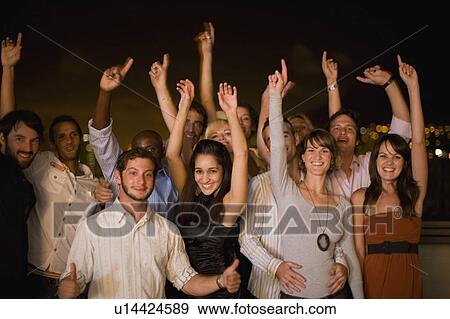 People cheering at party at night View Large Photo Image Stock Photo - People cheering at party at night. Fotosearch