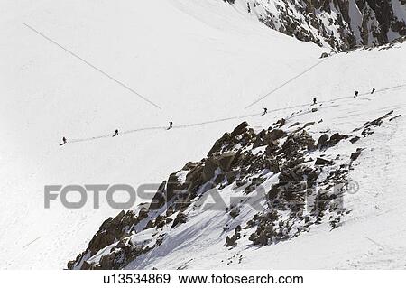 People hiking on snow covered mountain View Large Photo Image Stock Photo - People hiking on snow covered mountain. Fotosearch