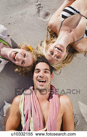 People lying in formation on beach View Large Photo Image Stock Photography - People lying in formation on beach. Fotosearch