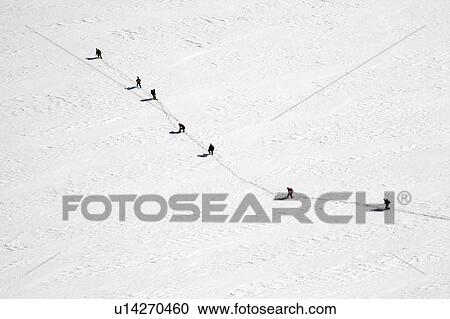 People walking in snow covered field View Large Photo Image Stock Image - People walking in snow covered field. Fotosearch
