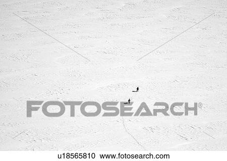 People walking in snow covered field View Large Photo Image Stock Image - People walking in snow covered field. Fotosearch