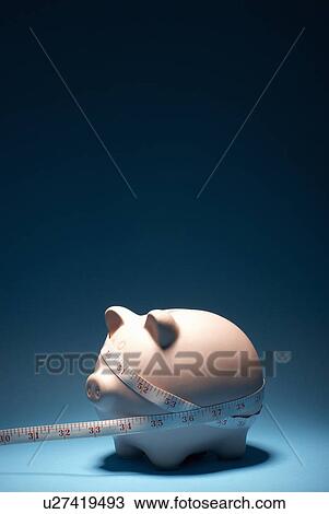 Piggy bank and measuring tape View Large Photo Image Stock Image - Piggy bank and measuring tape. Fotosearch