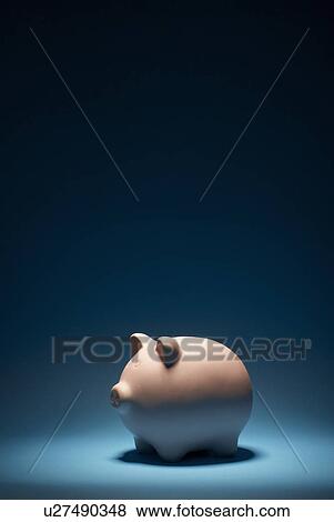 Piggy bank on blue background View Large Photo Image Stock Photo - Piggy bank on blue background. Fotosearch