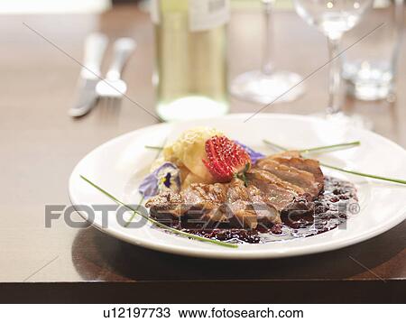 Plate of duck and potatoes at restaurant View Large Photo Image Stock Image - Plate of duck and potatoes at restaurant. Fotosearch