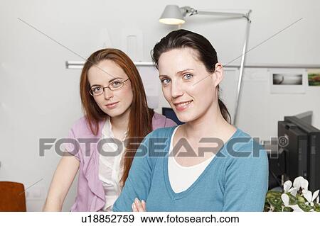 Stock Photo - Portrait of 2 women in a office. Fotosearch