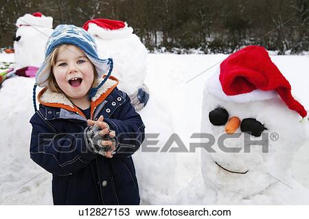 Portrait of a boy and some snowmen View Large Photo Image Stock Image - Portrait of a boy and some snowmen. Fotosearch