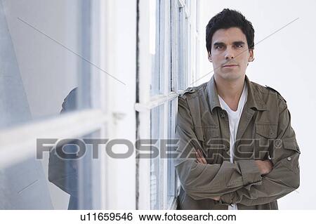 Stock Photograph - Portrait of a man, arms crossed. Fotosearch