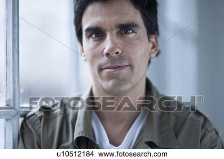 Picture - portrait of a man by a window. Fotosearch