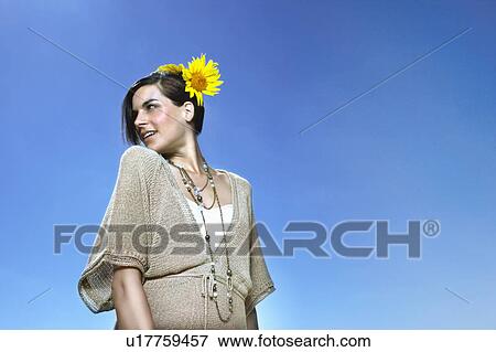 Portrait of a woman against blue sky View Large Photo Image Stock Photo - Portrait of a woman against blue sky. Fotosearch