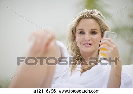 Portrait of a woman drinking orange juice View Large Photo Image Stock Photograph - Portrait of a woman drinking orange juice. Fotosearch