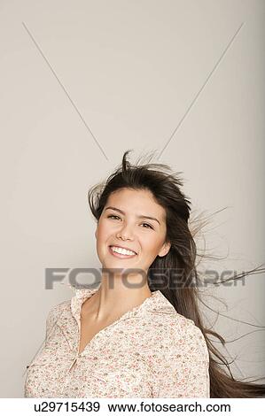 Portrait of a young woman smiling View Large Photo Image Stock Photo - Portrait of a young woman smiling. Fotosearch