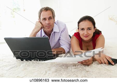 Stock Image - Portrait of couple paying bills. Fotosearch