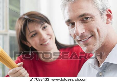 Portrait of happy couple cooking View Large Photo Image Stock Image - Portrait of happy couple cooking. Fotosearch