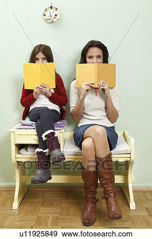 Stock Photo - portrait of mother and daughter reading. Fotosearch