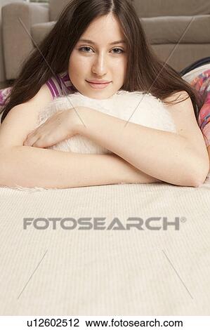 portrait of teenage girl lying on sofa View Large Photo Image Stock Image - portrait of teenage girl lying on sofa. Fotosearch