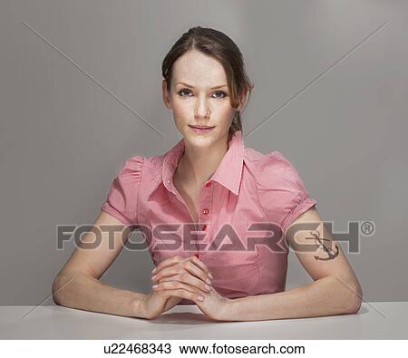 Stock Image - Portrait of Women with Anchor Tatoo. Fotosearch