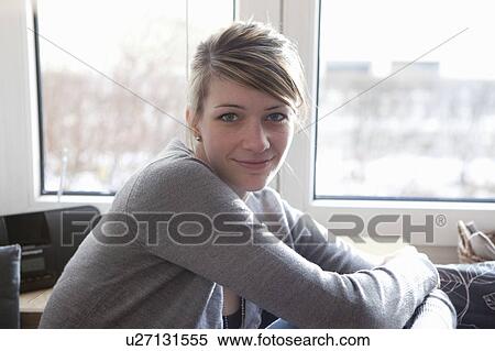 Portrait of young woman in her home View Large Photo Image Stock Photography - Portrait of young woman in her home. Fotosearch