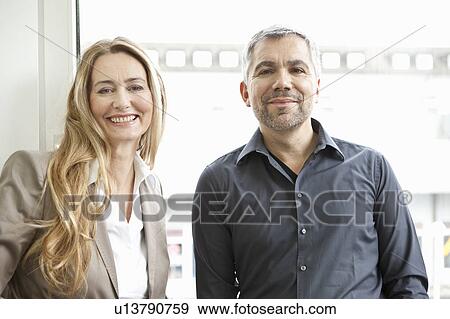 Stock Photo - Portrait ofmiddle aged man and woman. Fotosearch