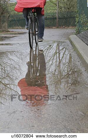 Picture - Reflection of man cycling. Fotosearch