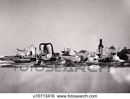 Stock Photograph - Remnants of a sumptuous dinner party. Fotosearch