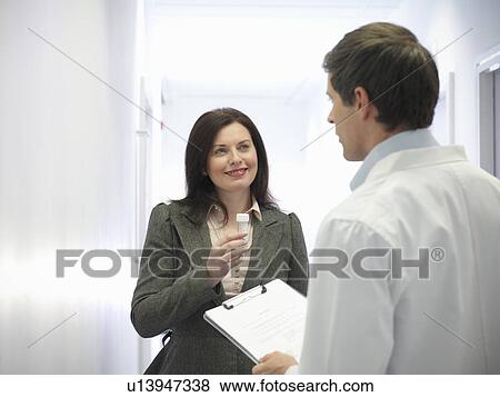 Stock Photo - Scientist and woman with sample. Fotosearch