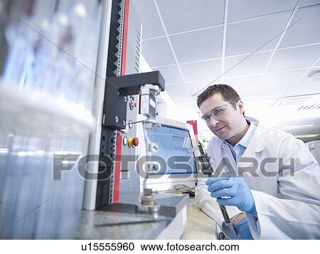Stock Image - Scientist conducting stretch test. Fotosearch