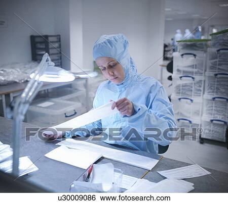 Stock Photograph - Scientist in clean room with product. Fotosearch