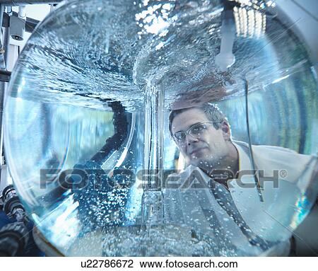 Scientist looking through mixing vessel View Large Photo Image Stock Image - Scientist looking through mixing vessel. Fotosearch