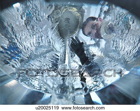 Scientist looking through mixing vessel View Large Photo Image Stock Photo - Scientist looking through mixing vessel. Fotosearch