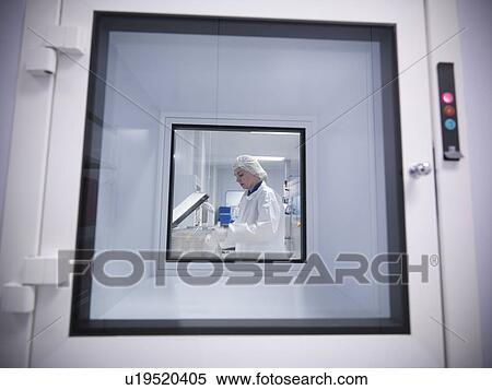 Stock Photography - Scientist through clean room hatch. Fotosearch