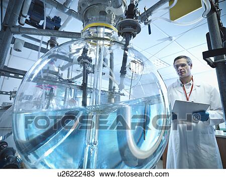 Scientist with laboratory mixing vessel View Large Photo Image Stock Image - Scientist with laboratory mixing vessel. Fotosearch