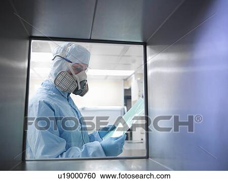 Stock Image - Scientist with product in clean room. Fotosearch