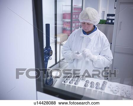 Stock Photo - Scientist with product in clean room. Fotosearch