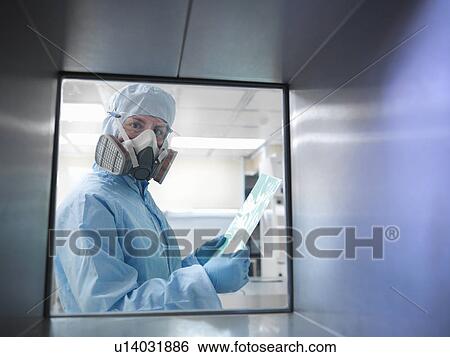 Stock Photograph - Scientist with product in clean room. Fotosearch