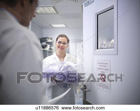 Stock Photograph - Scientist with product in laboratory. Fotosearch