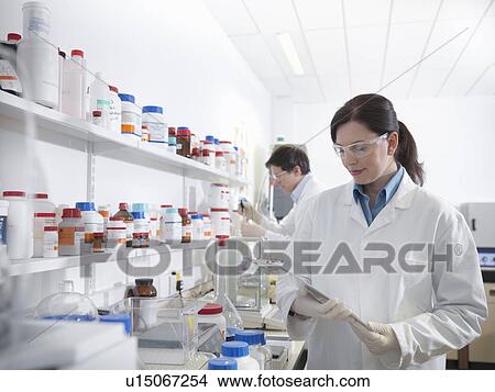Scientists conducting test in laboratory View Large Photo Image Picture - Scientists conducting test in laboratory. Fotosearch