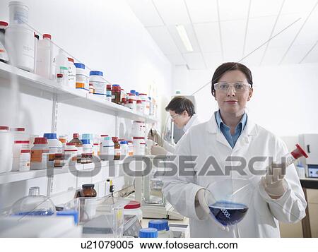 Scientists conducting test in laboratory View Large Photo Image Stock Photography - Scientists conducting test in laboratory. Fotosearch