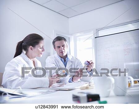 Scientists discuss product prototypes View Large Photo Image Stock Image - Scientists discuss product prototypes. Fotosearch