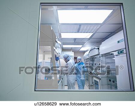 Scientists in laboratory clean room View Large Photo Image Stock Photo - Scientists in laboratory clean room. Fotosearch