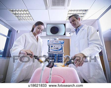 Stock Image - Scientists practice with simulator. Fotosearch