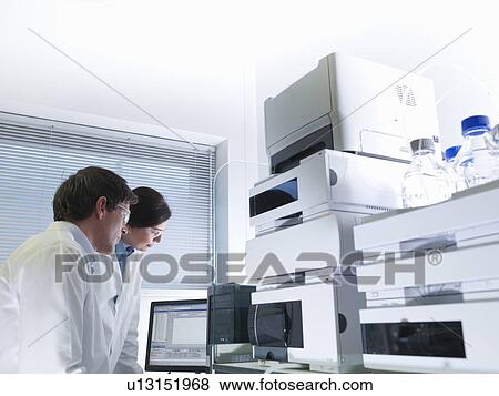 Scientists with electronic test machine View Large Photo Image Stock Photo - Scientists with electronic test machine. Fotosearch