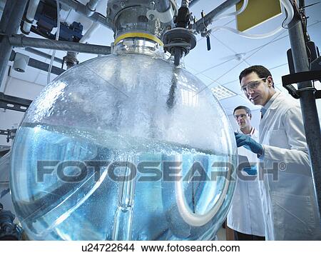 Picture - Scientists with laboratory mixing vessel. Fotosearch
