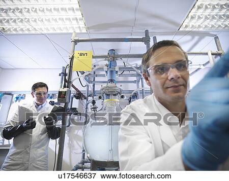 Scientists with laboratory mixing vessel View Large Photo Image Stock Photo - Scientists with laboratory mixing vessel. Fotosearch