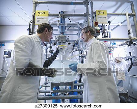 Stock Photography - Scientists with laboratory mixing vessel. Fotosearch