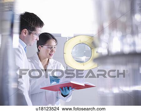 Scientists with notes in laboratory View Large Photo Image Picture - Scientists with notes in laboratory. Fotosearch