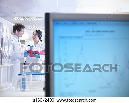 Scientists with notes in laboratory View Large Photo Image Stock Photo - Scientists with notes in laboratory. Fotosearch