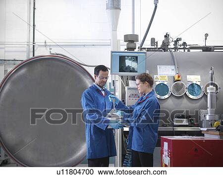 Scientists with product and vacuum tank View Large Photo Image Stock Image - Scientists with product and vacuum tank. Fotosearch