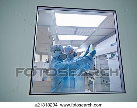 Scientists with product in clean room View Large Photo Image Picture - Scientists with product in clean room. Fotosearch