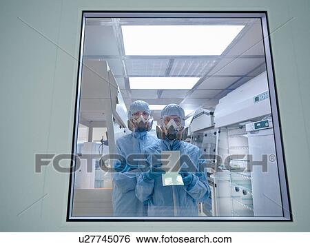 Stock Photograph - Scientists with product in clean room. Fotosearch