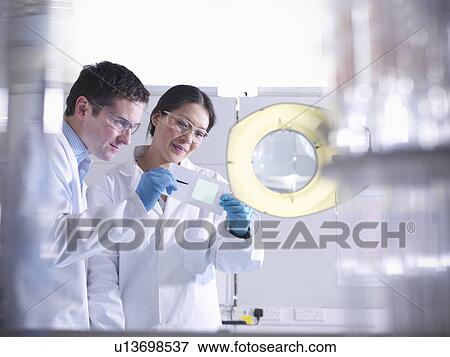 Scientists with product in laboratory View Large Photo Image Stock Photo - Scientists with product in laboratory. Fotosearch